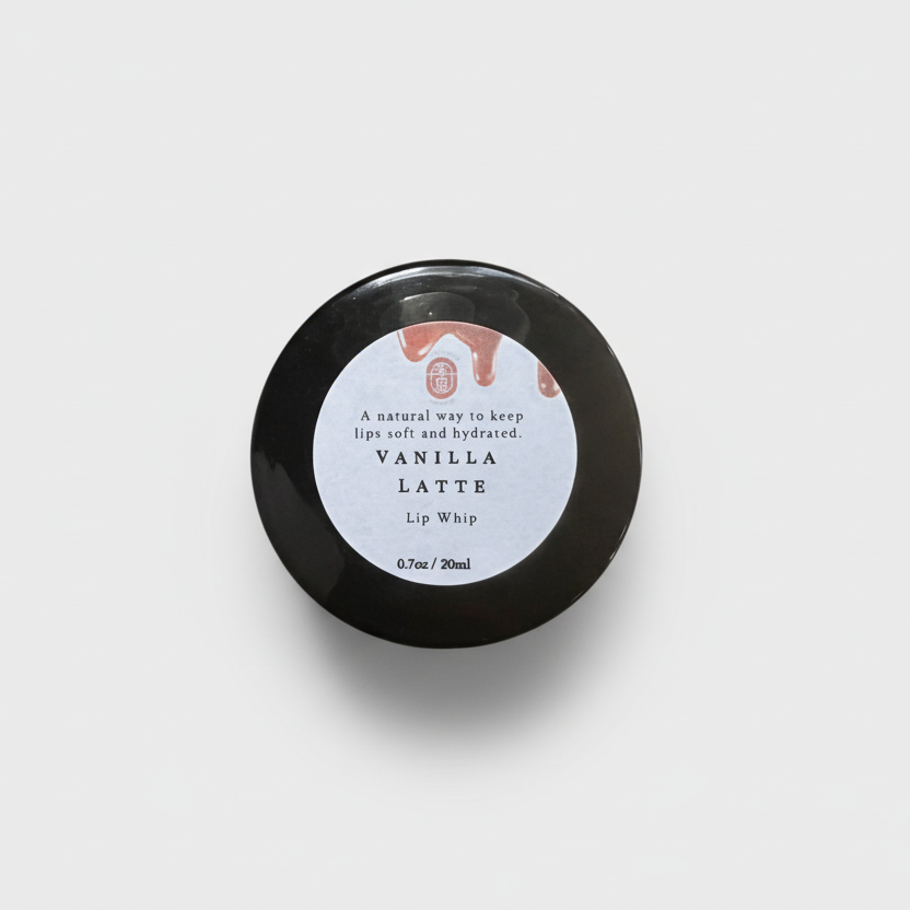 Black lip balm container with a white label on a white background