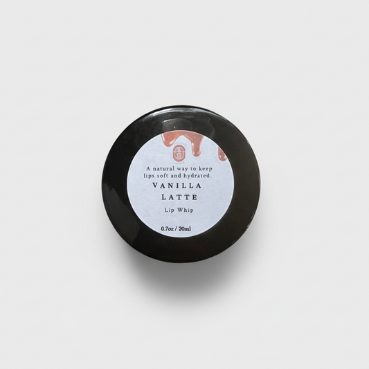 Black lip balm container with a white label on a white background
